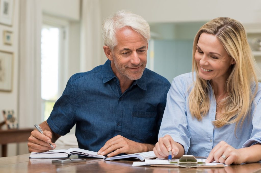 photo of man and woman reviewing define benefit and defined contribution plans
