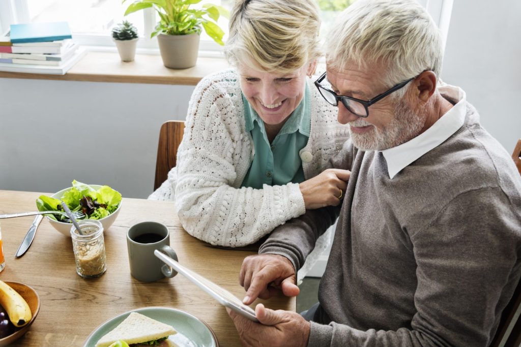 photo of man and woman reviewing retirement plan information